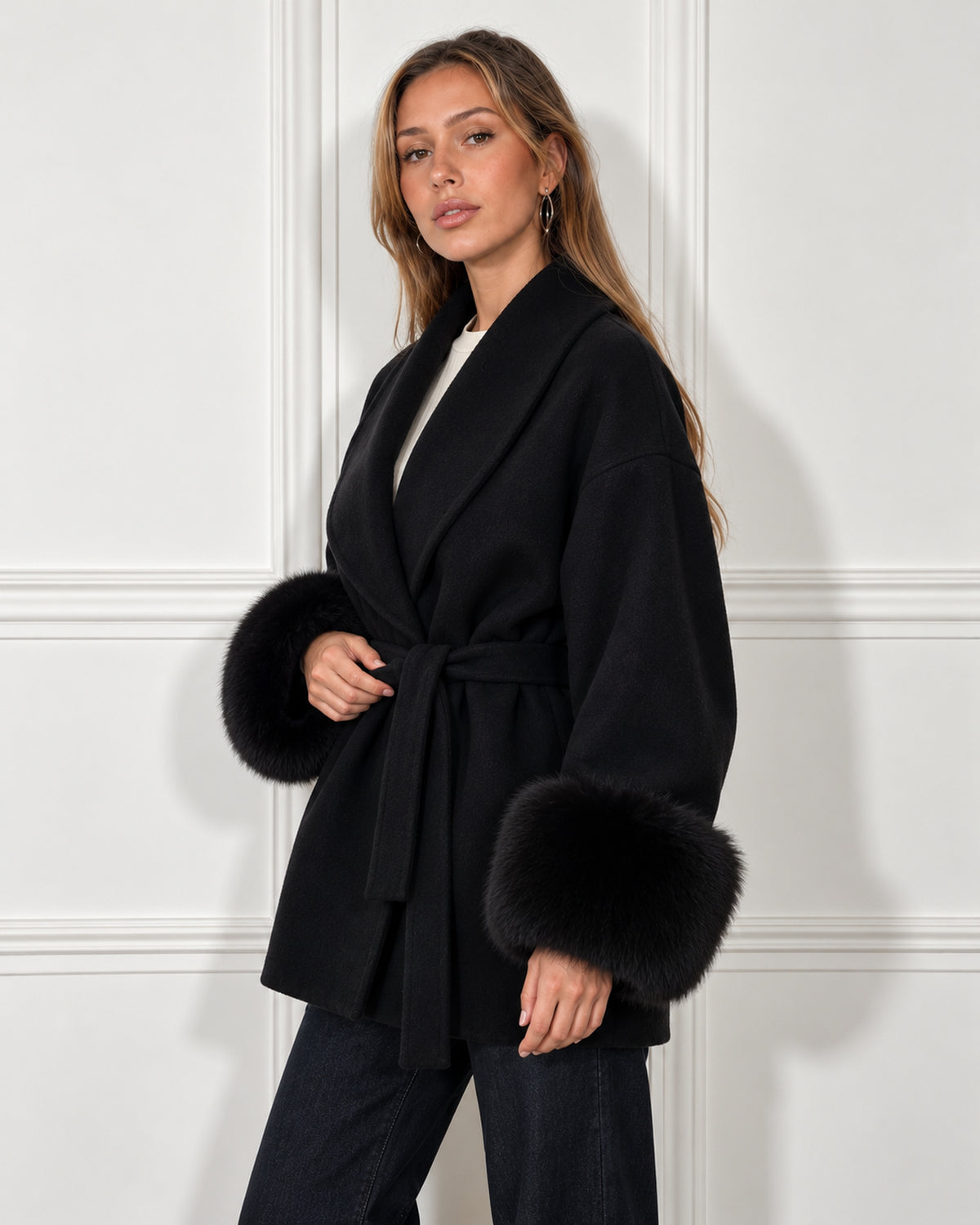 Belted shawl-collar coat in black, worn by a model