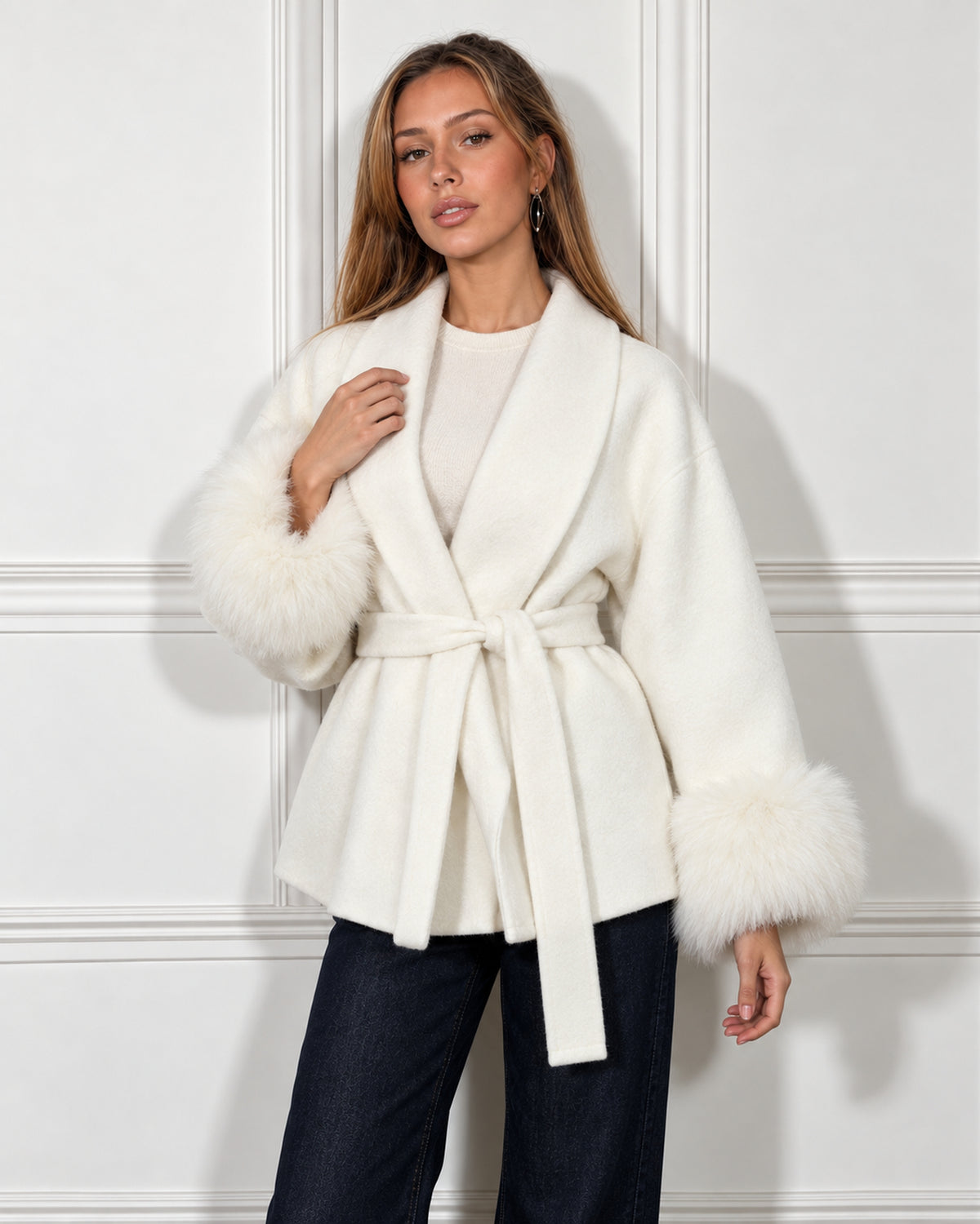 Belted shawl-collar coat in white, worn by a model