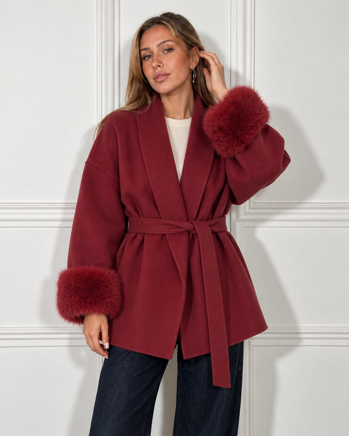 Belted shawl-collar coat in wine red, worn by a model