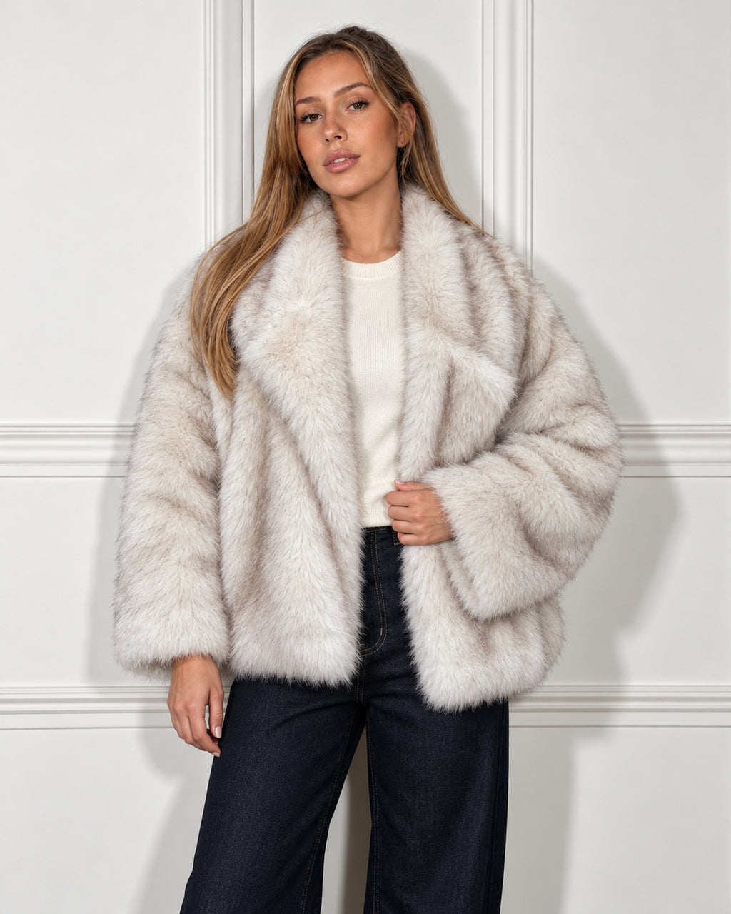 Oversized faux fur jacket in cream, worn by a model with wide-leg jeans