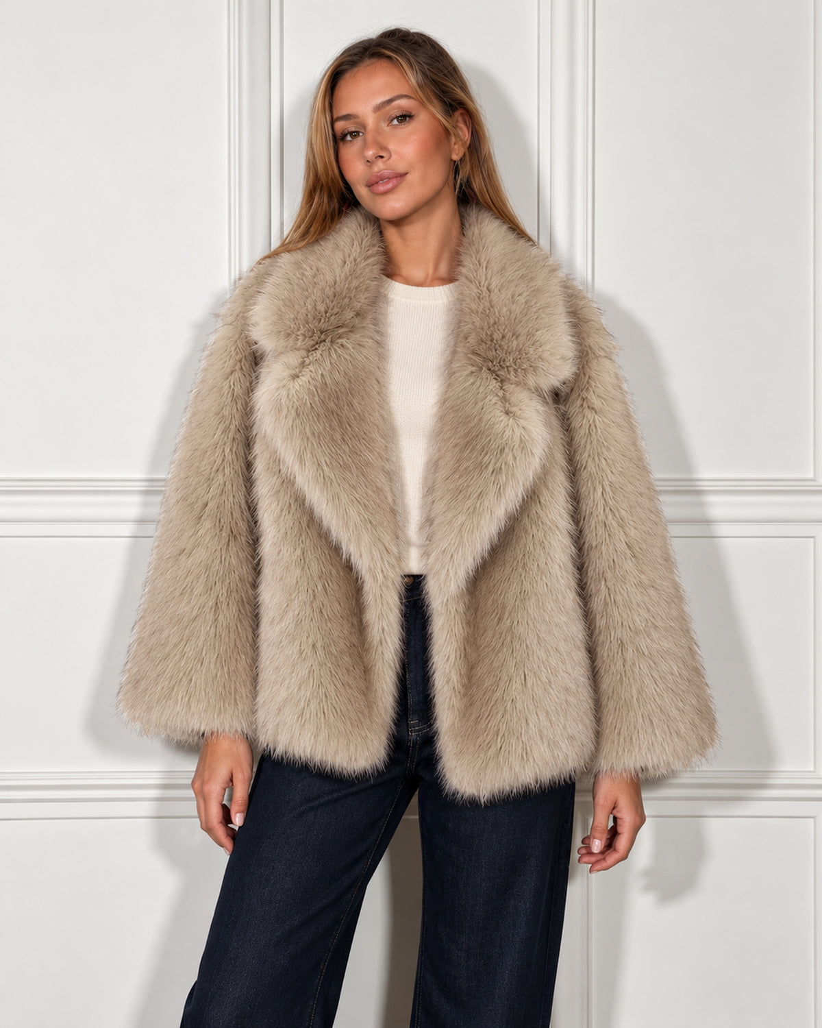 Oversized faux fur jacket in taupe, worn by a model, standing