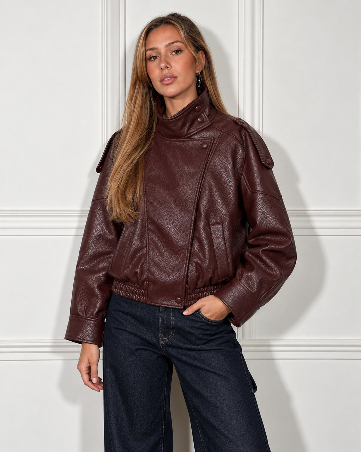 Cropped leather moto jacket in burgundy, worn by a model, front