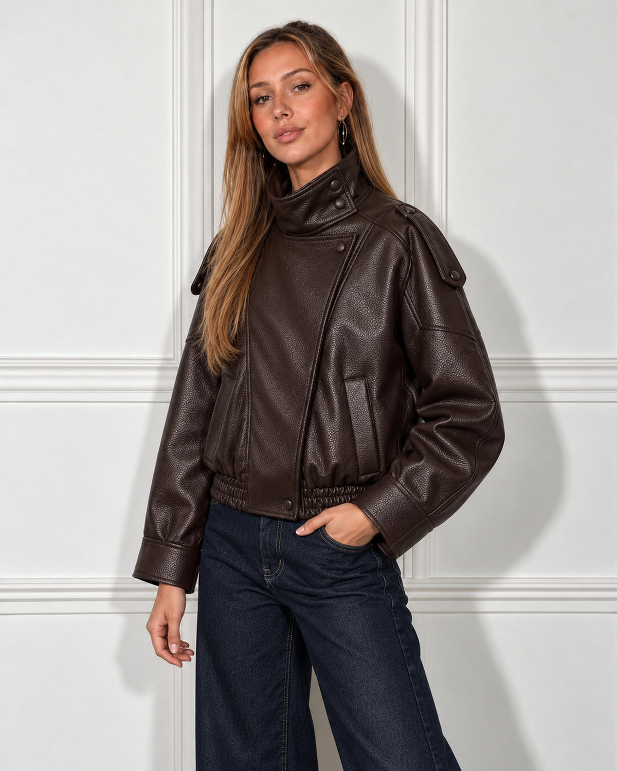 Cropped leather moto jacket in dark brown, worn by a model, front