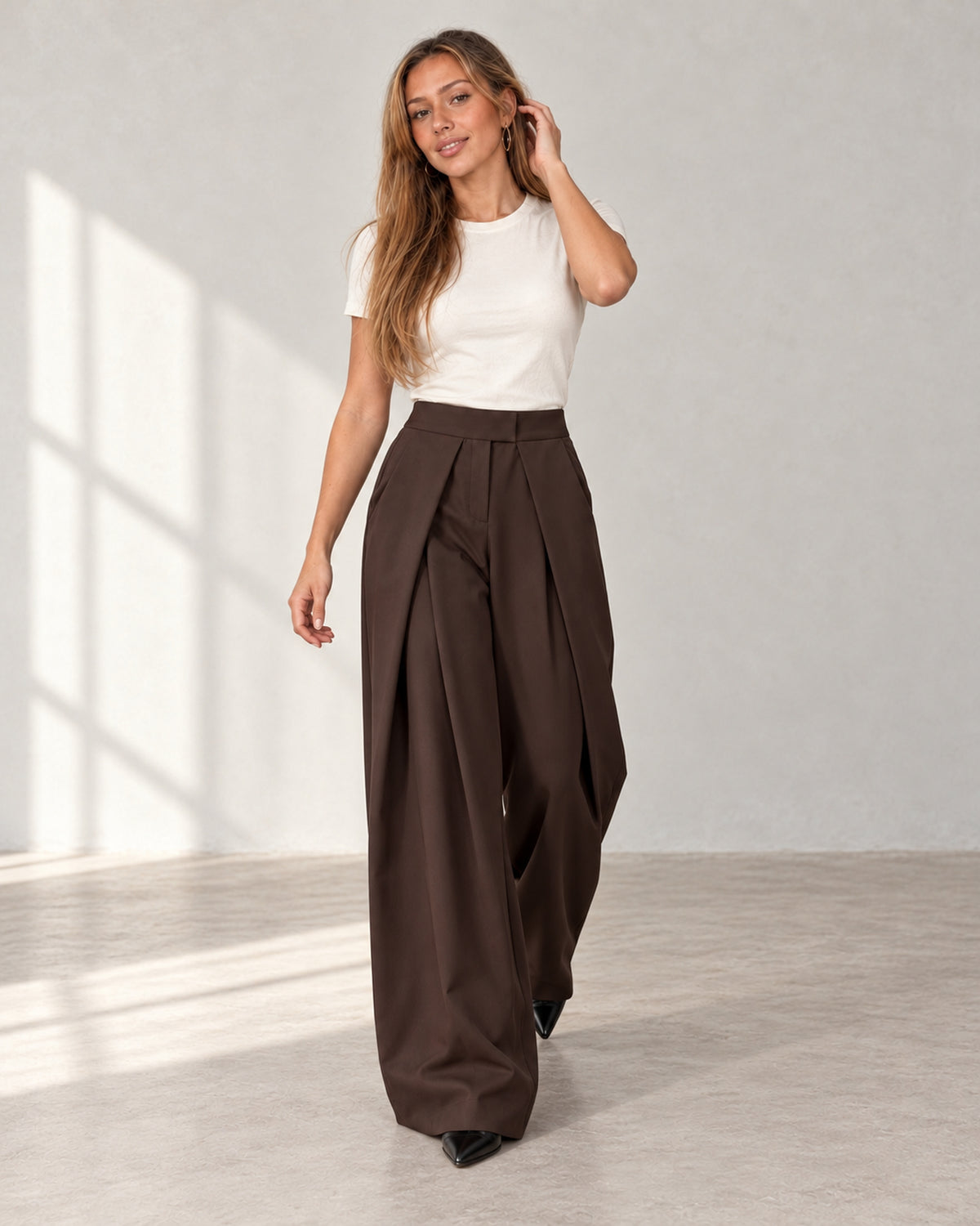 Pleated wide-leg trousers in chocolate brown, worn by a model