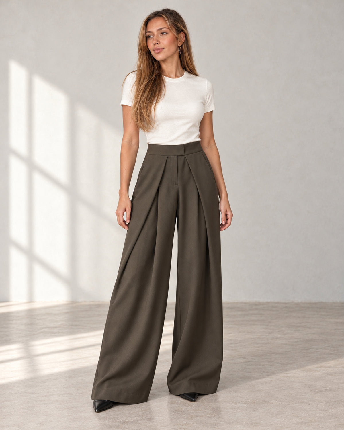 Pleated wide-leg trousers in olive, worn by a model
