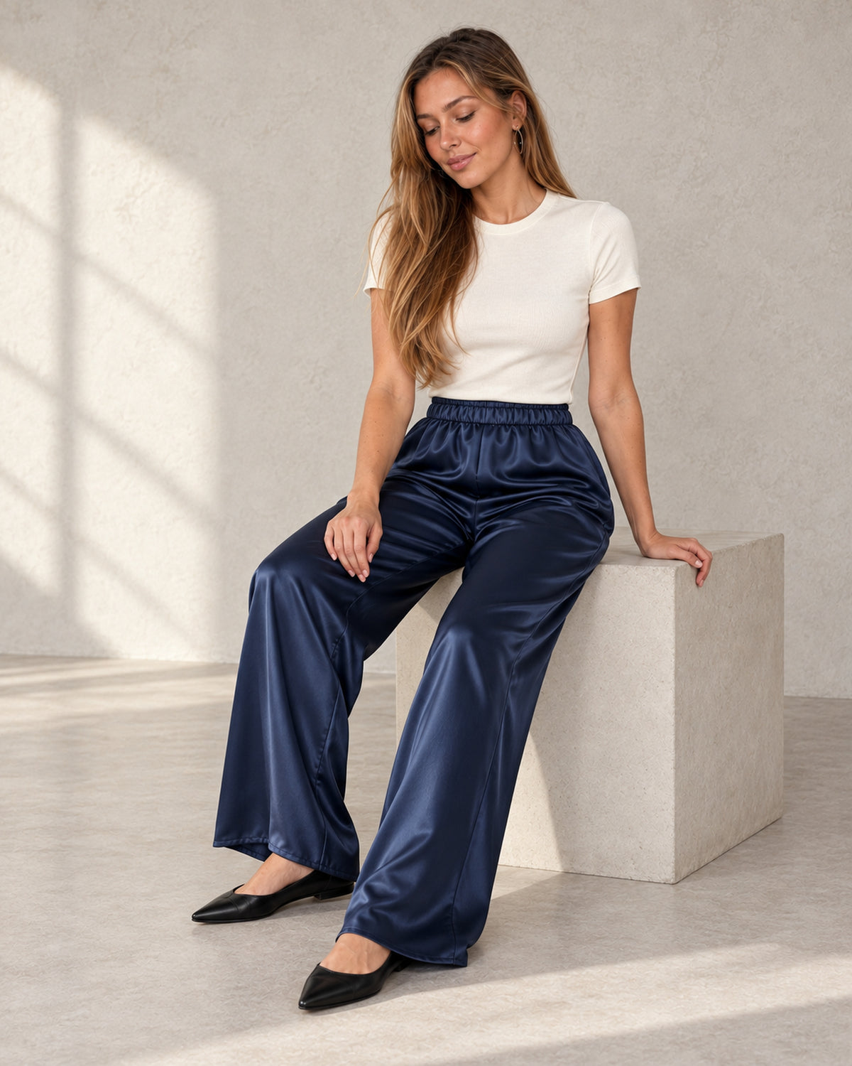 Satin wide-leg trousers in navy, worn by a model