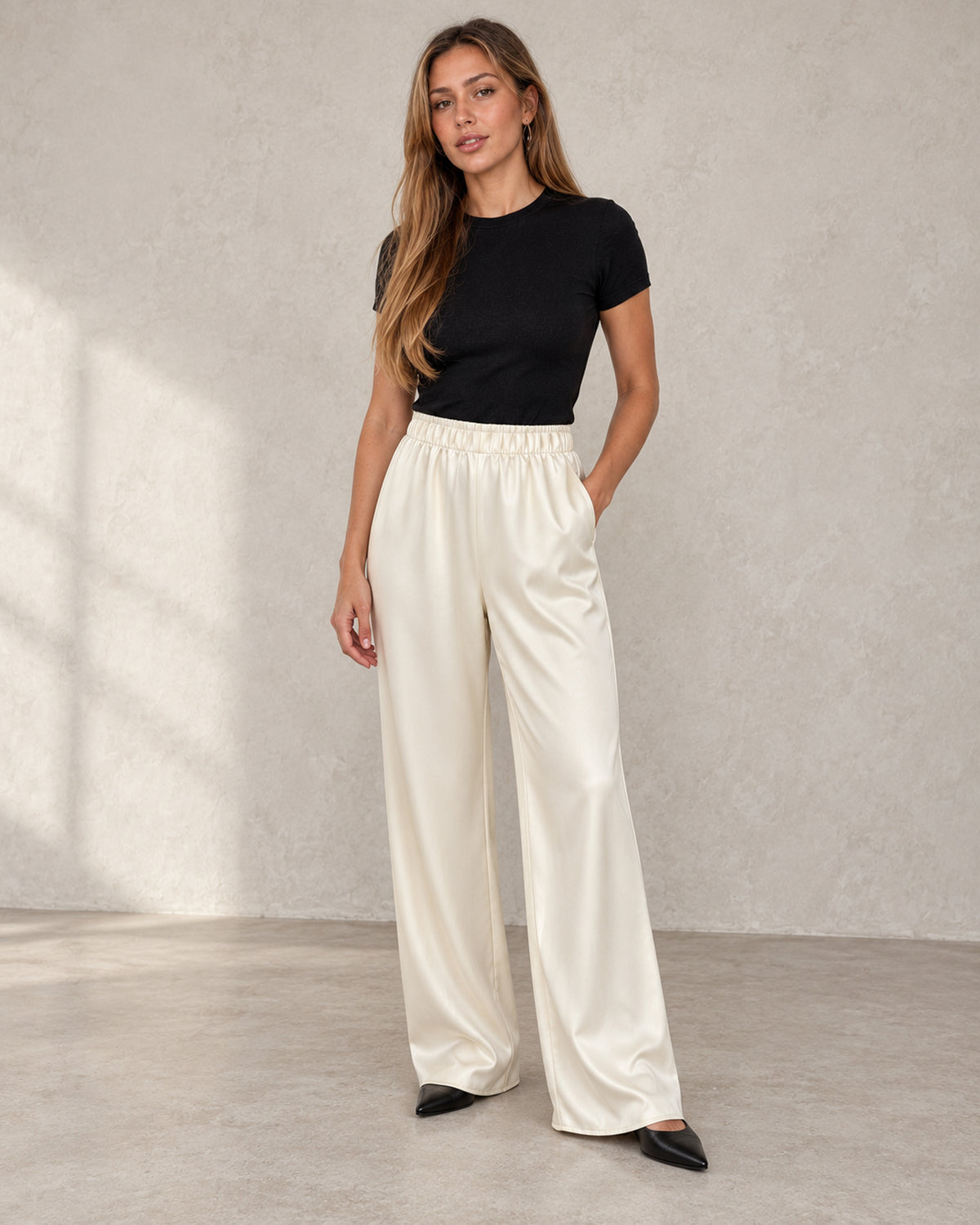 Satin wide-leg trousers in sand, worn by a model
